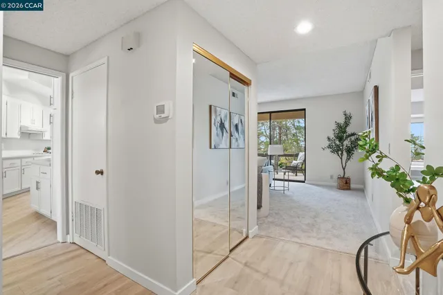 a view of a hallway to a livingroom with furniture