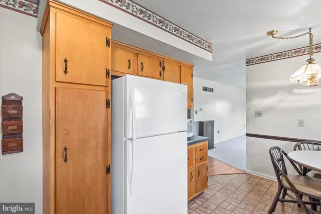 a white refrigerator freezer sitting in a kitchen