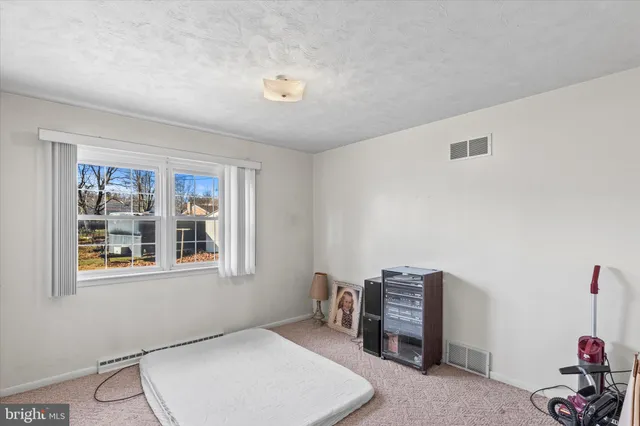 a bedroom with furniture and window