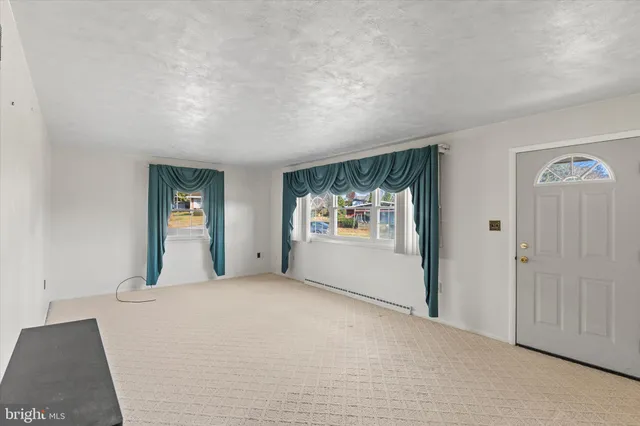 a view of a big room with windows and cabinet