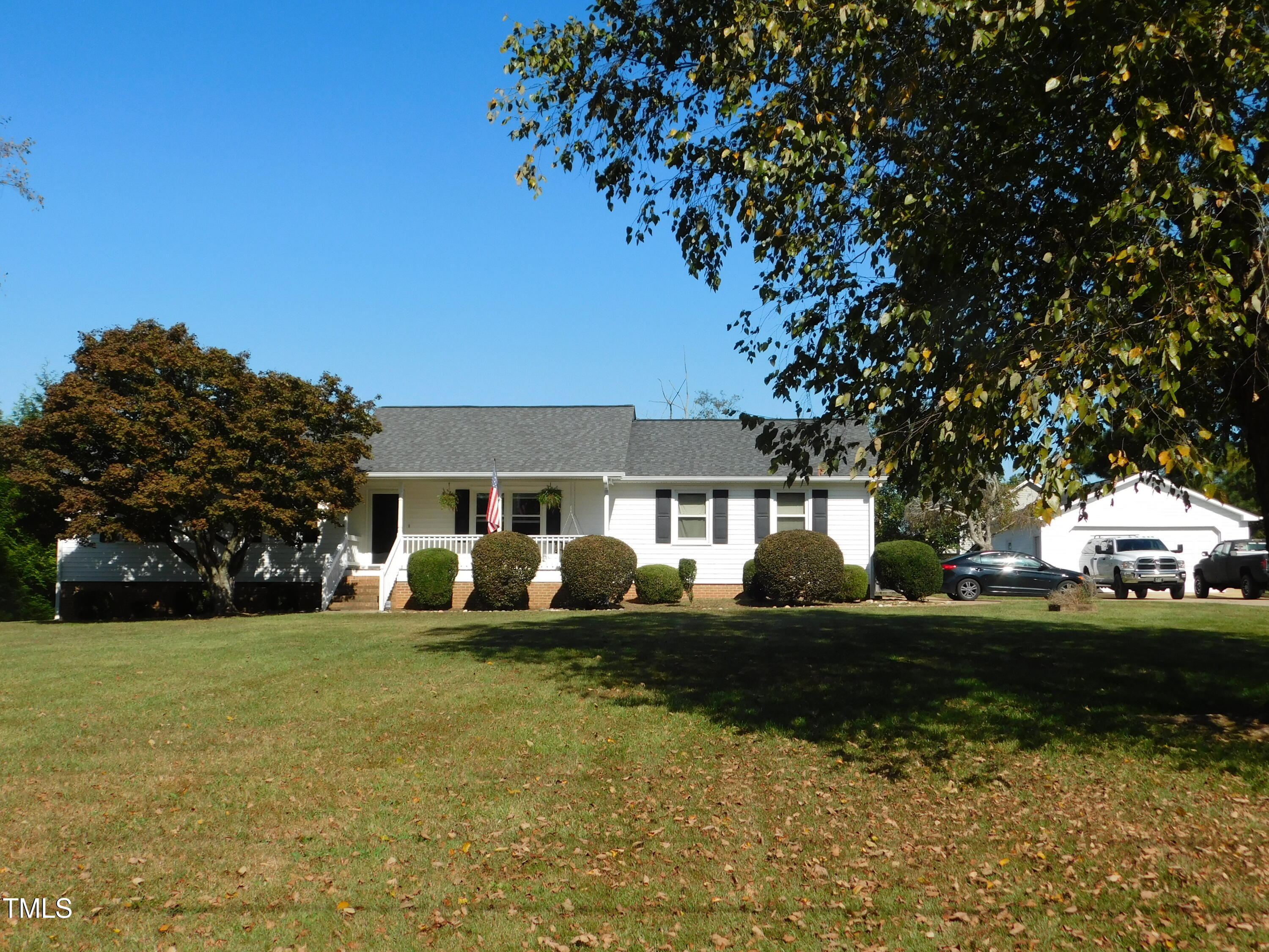 1168 Earpsboro Road Zebulon, NC 27597 - Photo 3 of 25 a front view of a house with a garden and trees
