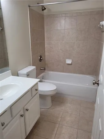 a bathroom with a toilet a sink and bathtub