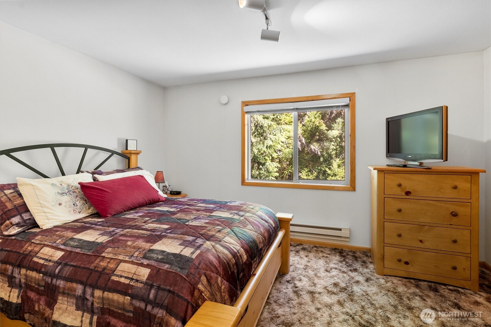 7101 Rainier Way Glacier, WA 98244 - Photo 22 of 40 a bedroom with a bed and a flat tv screen