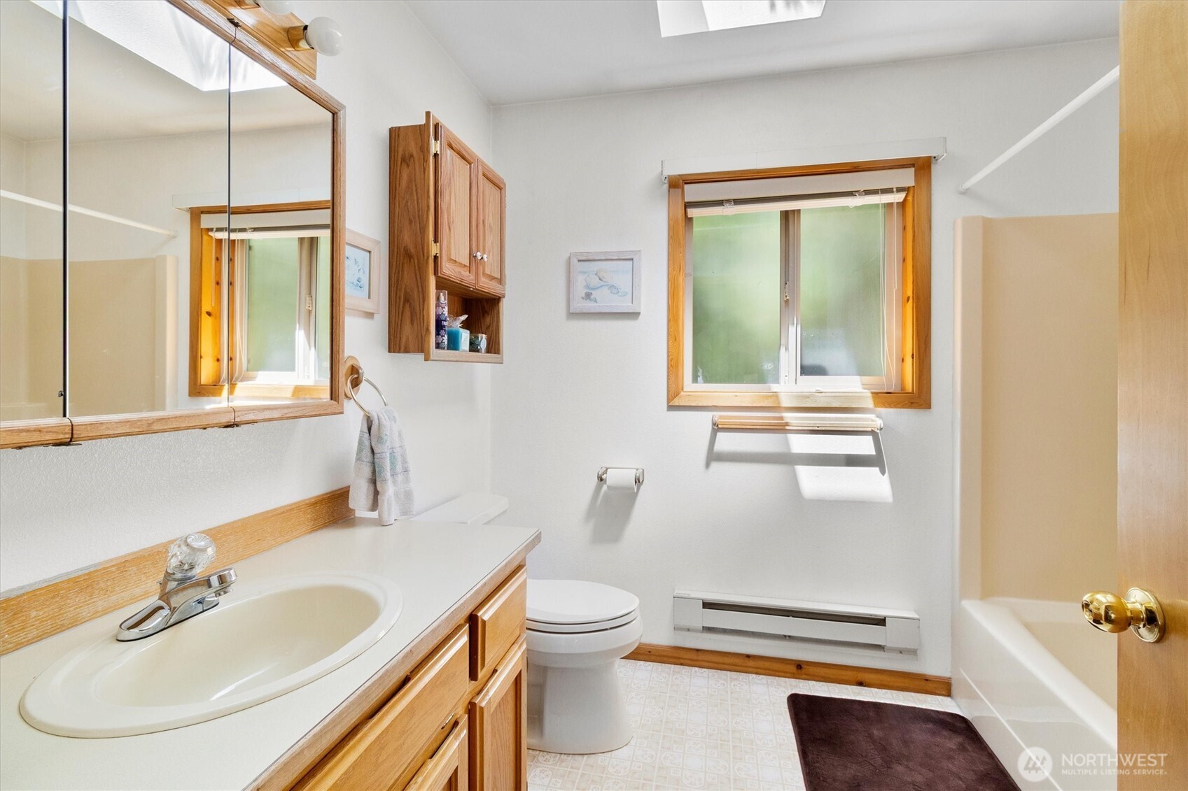 7101 Rainier Way Glacier, WA 98244 - Photo 24 of 40 a bathroom with a sink a toilet and a mirror