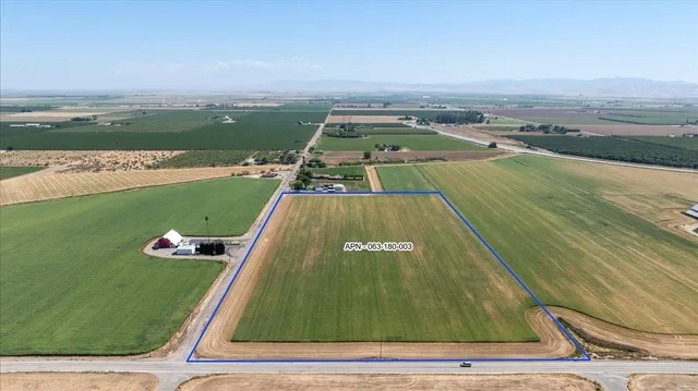 an aerial view of a swimming pool with a yard