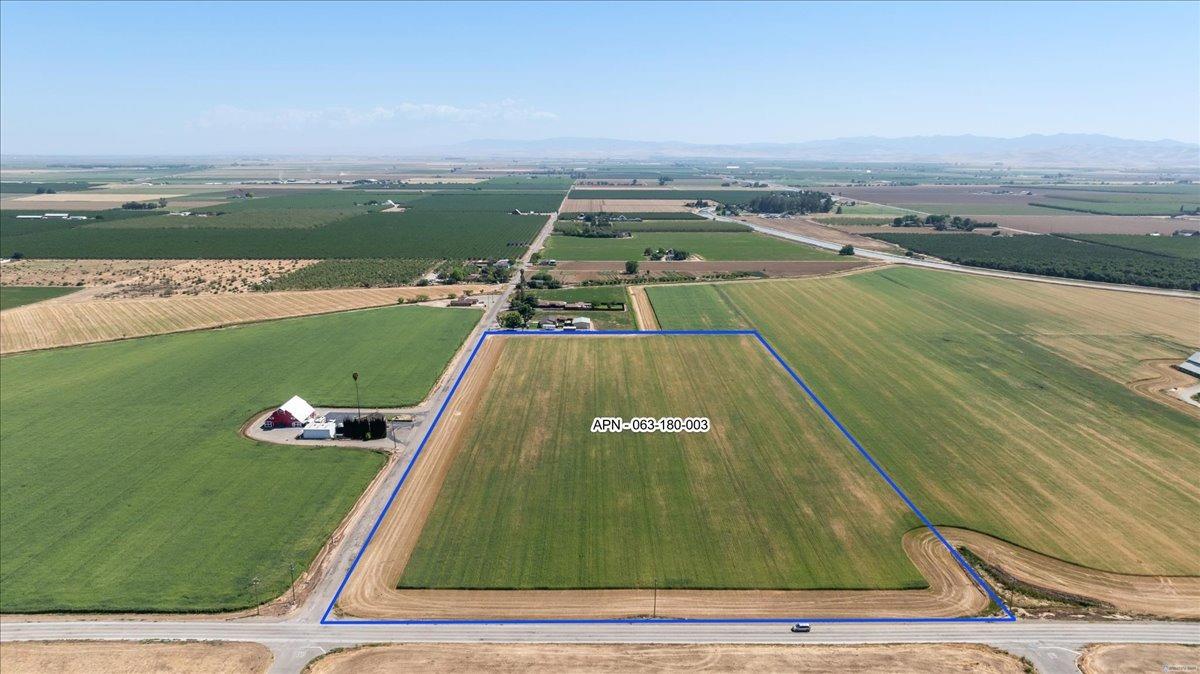 an aerial view of a swimming pool with a yard