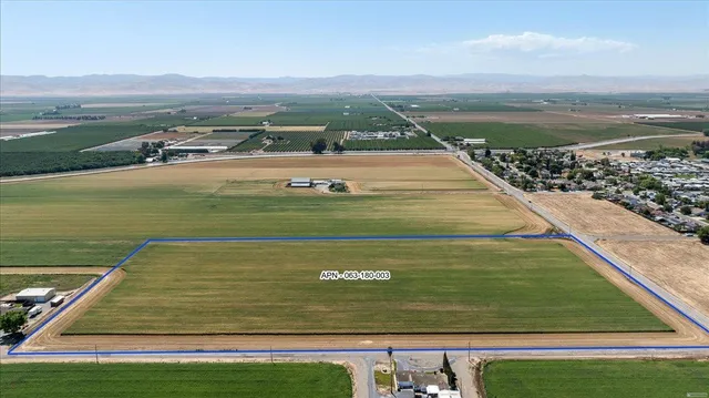 an aerial view of a pool and mountain