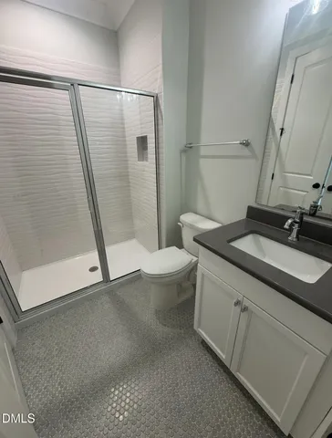 a bathroom with double vanity and a mirror