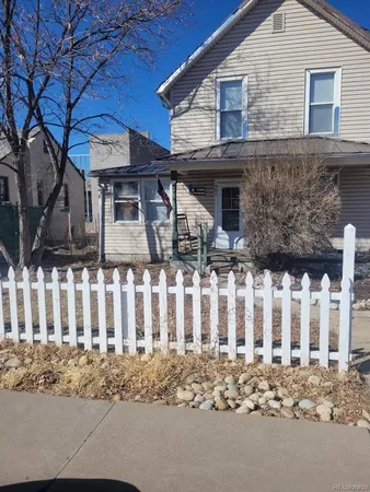 a front view of house with wooden fence