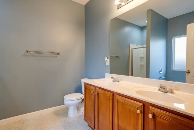 a bathroom with a sink a toilet and a mirror