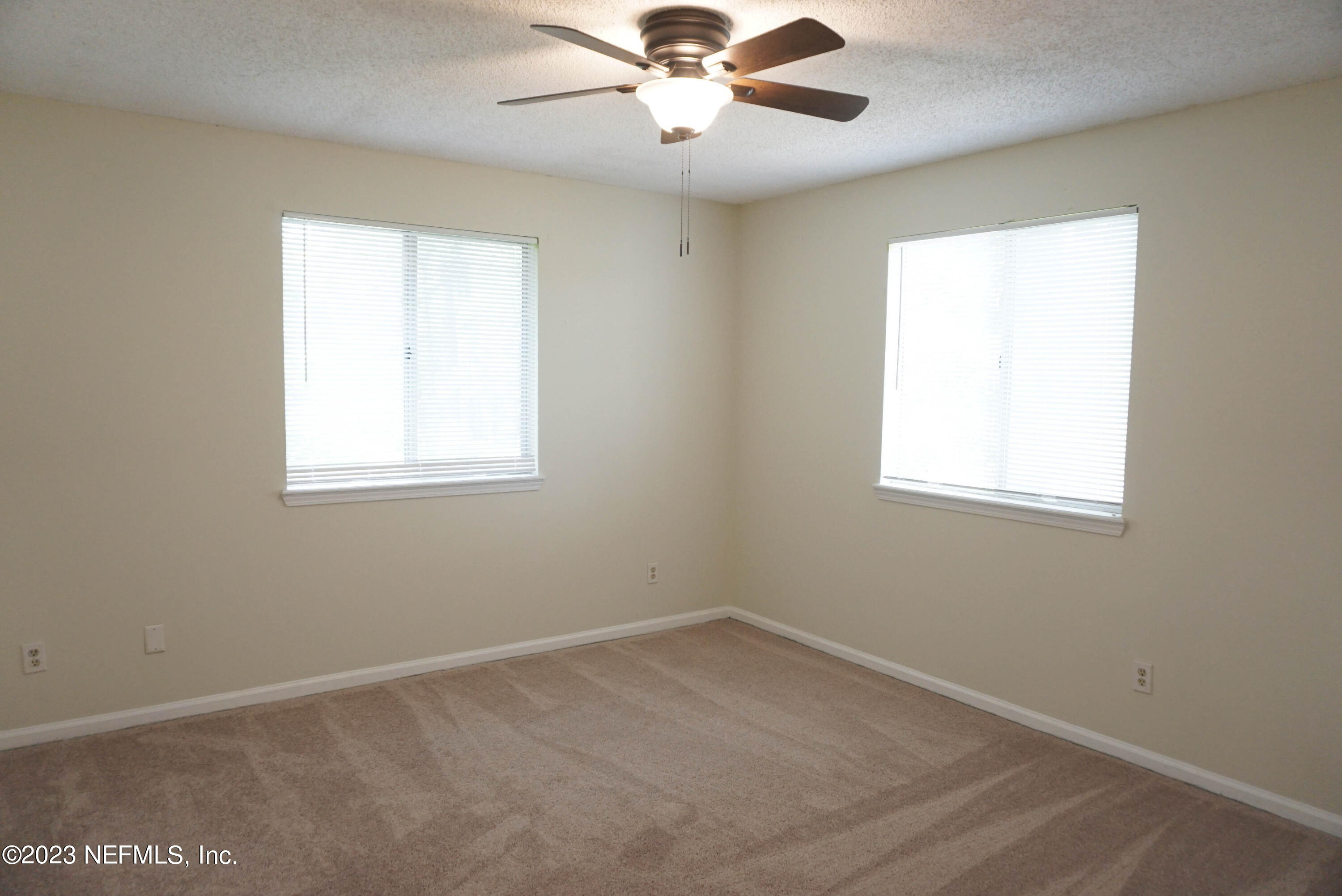 3270 Ricky Drive, Unit 803 Jacksonville, FL 32223 - Photo 11 of 16 an empty room with a window and a fan