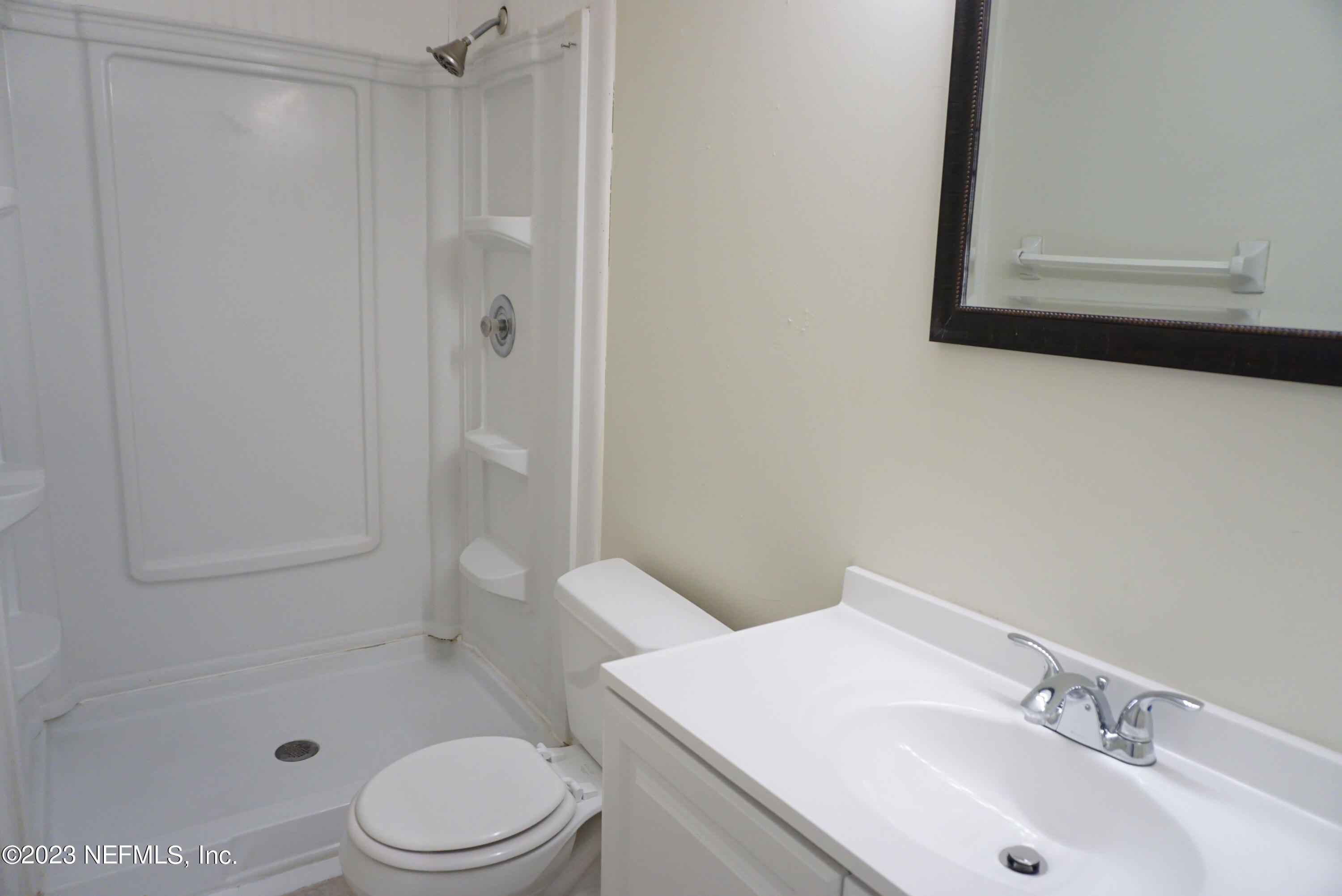 3270 Ricky Drive, Unit 803 Jacksonville, FL 32223 - Photo 12 of 16 a bathroom with a sink a toilet and shower