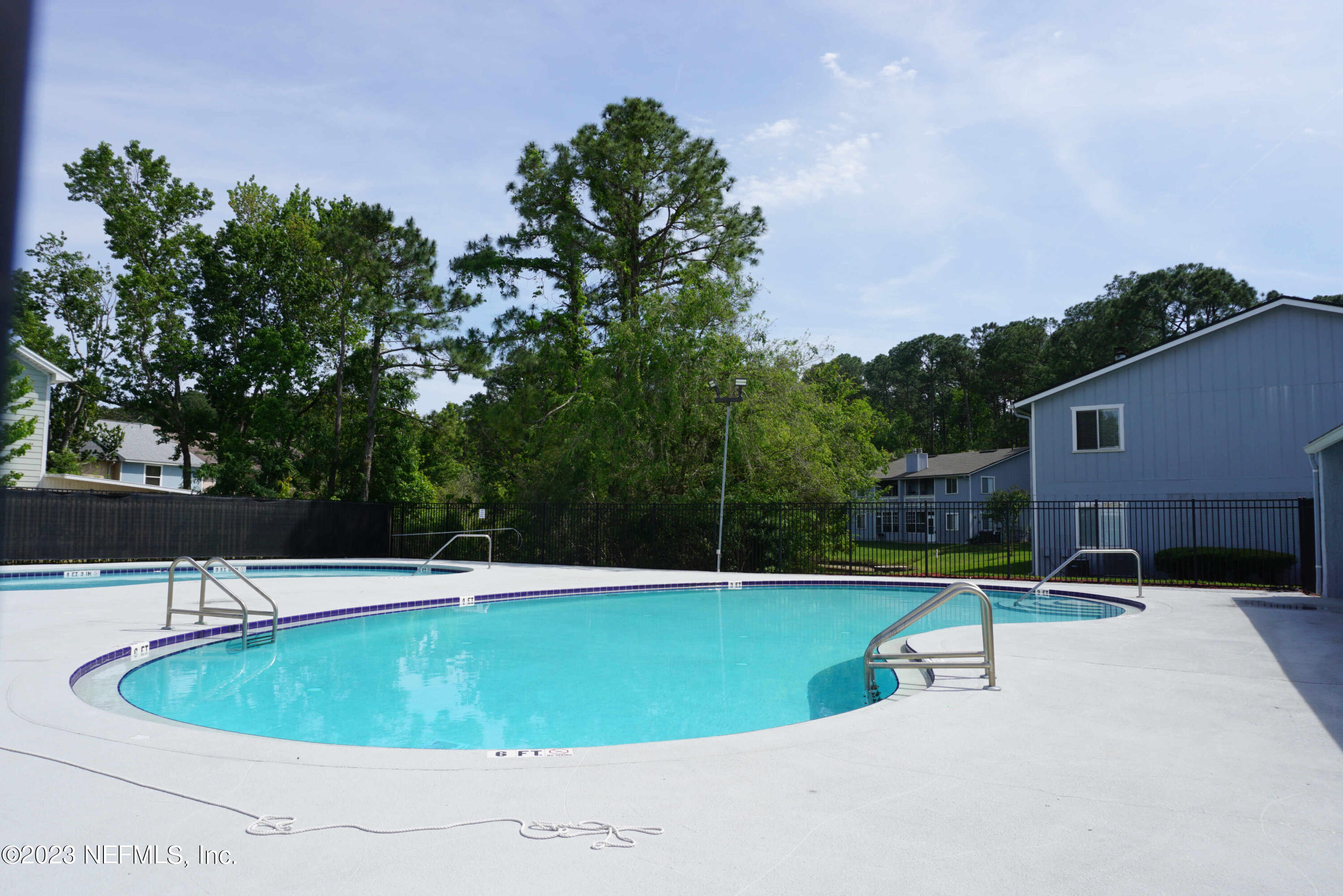3270 Ricky Drive, Unit 803 Jacksonville, FL 32223 - Photo 15 of 16 a view of a swimming pool with lawn chairs under an umbrella
