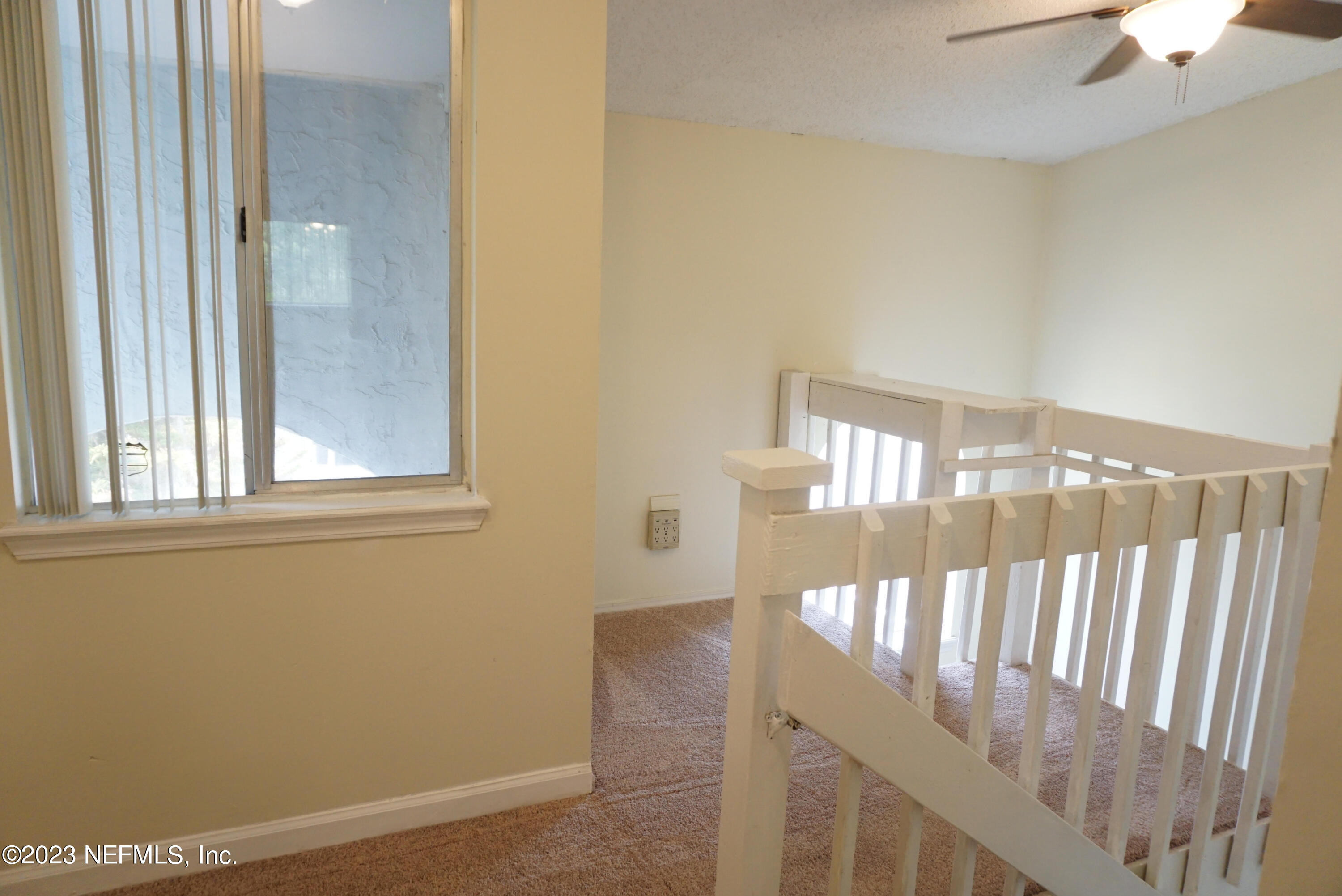 3270 Ricky Drive, Unit 803 Jacksonville, FL 32223 - Photo 4 of 16 a view of staircase with railing and a chandelier