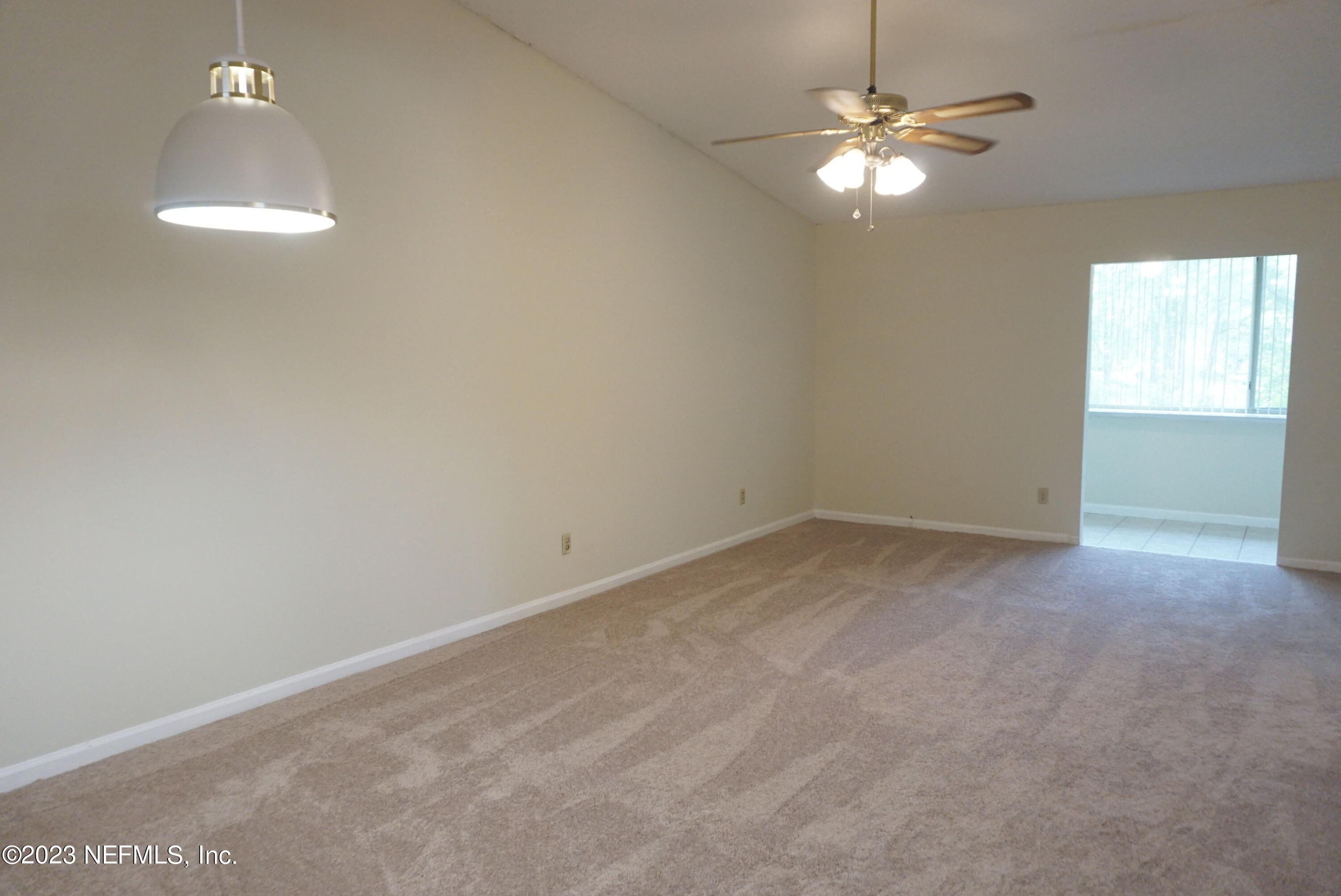 3270 Ricky Drive, Unit 803 Jacksonville, FL 32223 - Photo 5 of 16 en empty room with windows and ceiling fan