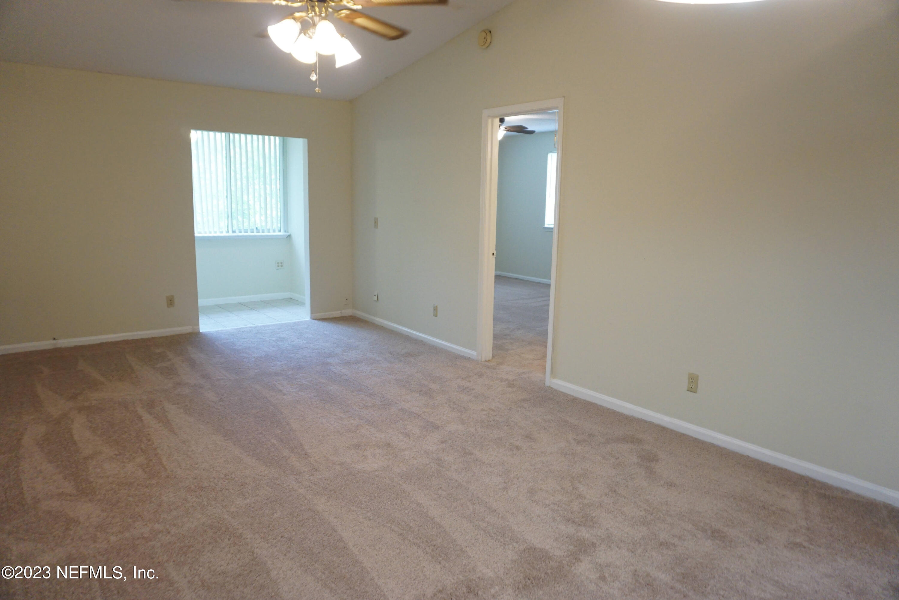 3270 Ricky Drive, Unit 803 Jacksonville, FL 32223 - Photo 6 of 16 an empty room with windows and fan