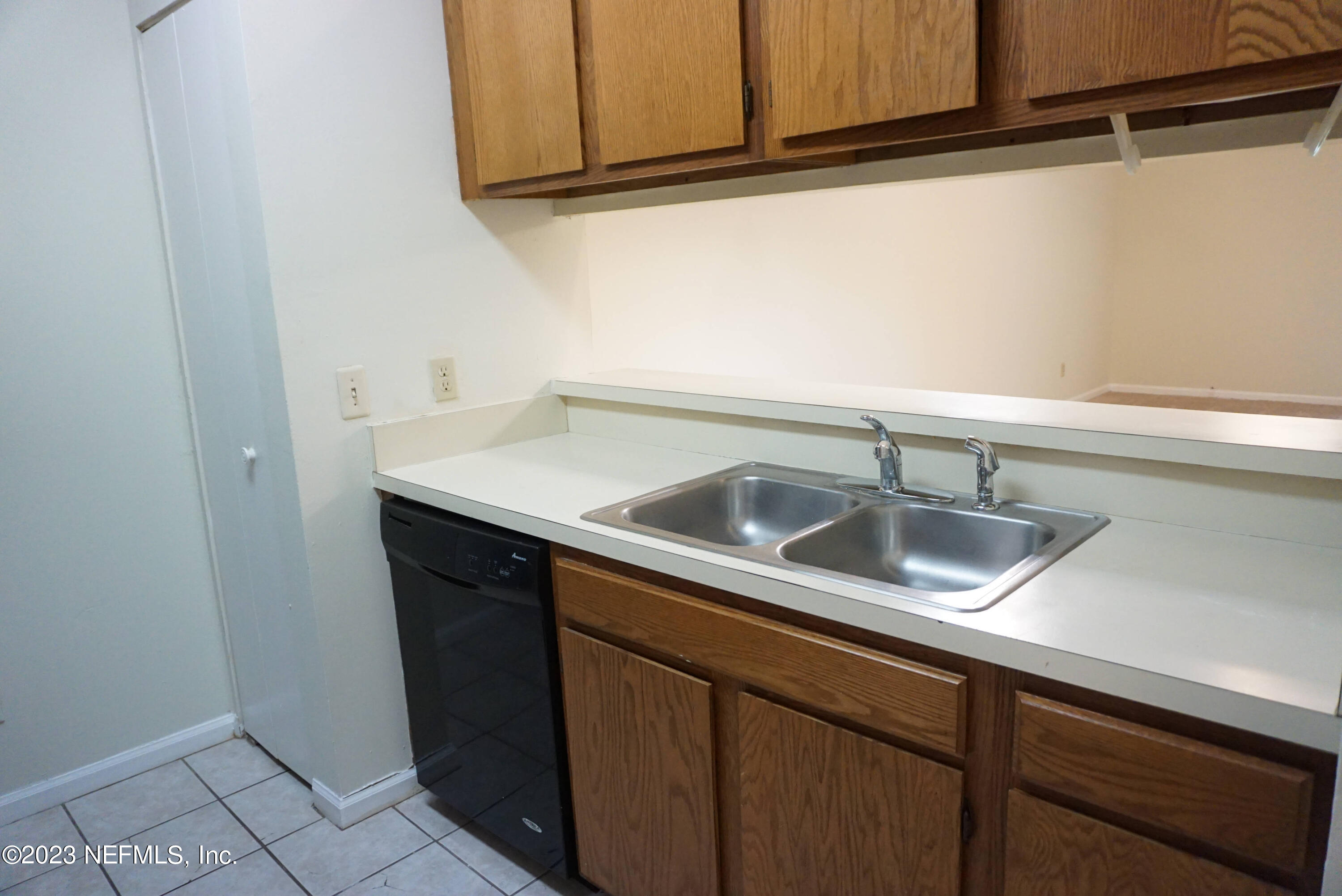 3270 Ricky Drive, Unit 803 Jacksonville, FL 32223 - Photo 10 of 16 a kitchen with a sink and cabinets