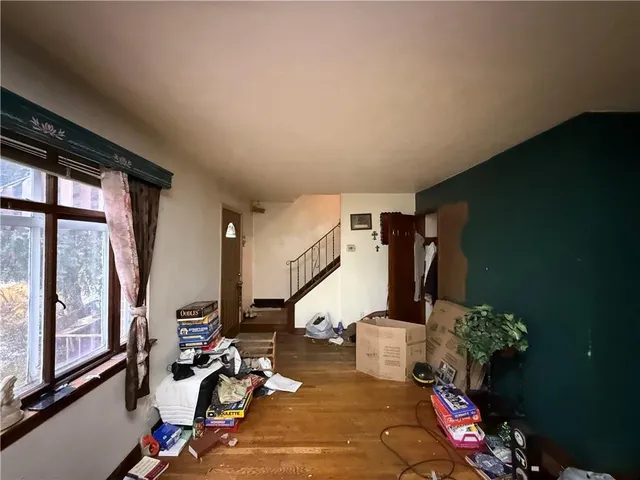 a gym room with gym equipment and a large window