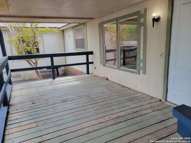 a bedroom with a bed and large window