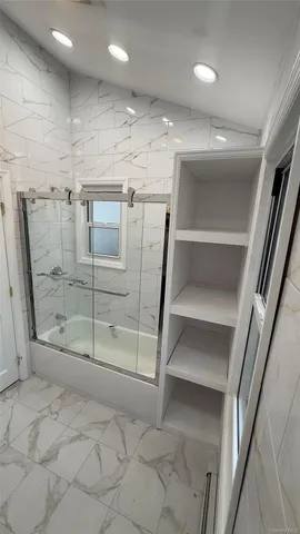 a view of an empty room with wooden floor and staircase