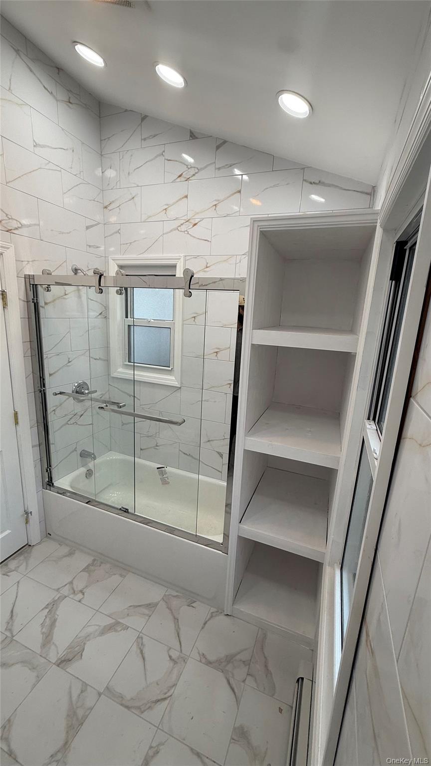 116-45 195th Street Queens, NY 11412 - Photo 12 of 21 a view of an empty room with wooden floor and staircase