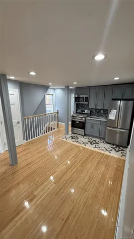 a large kitchen with stainless steel appliances a large counter top