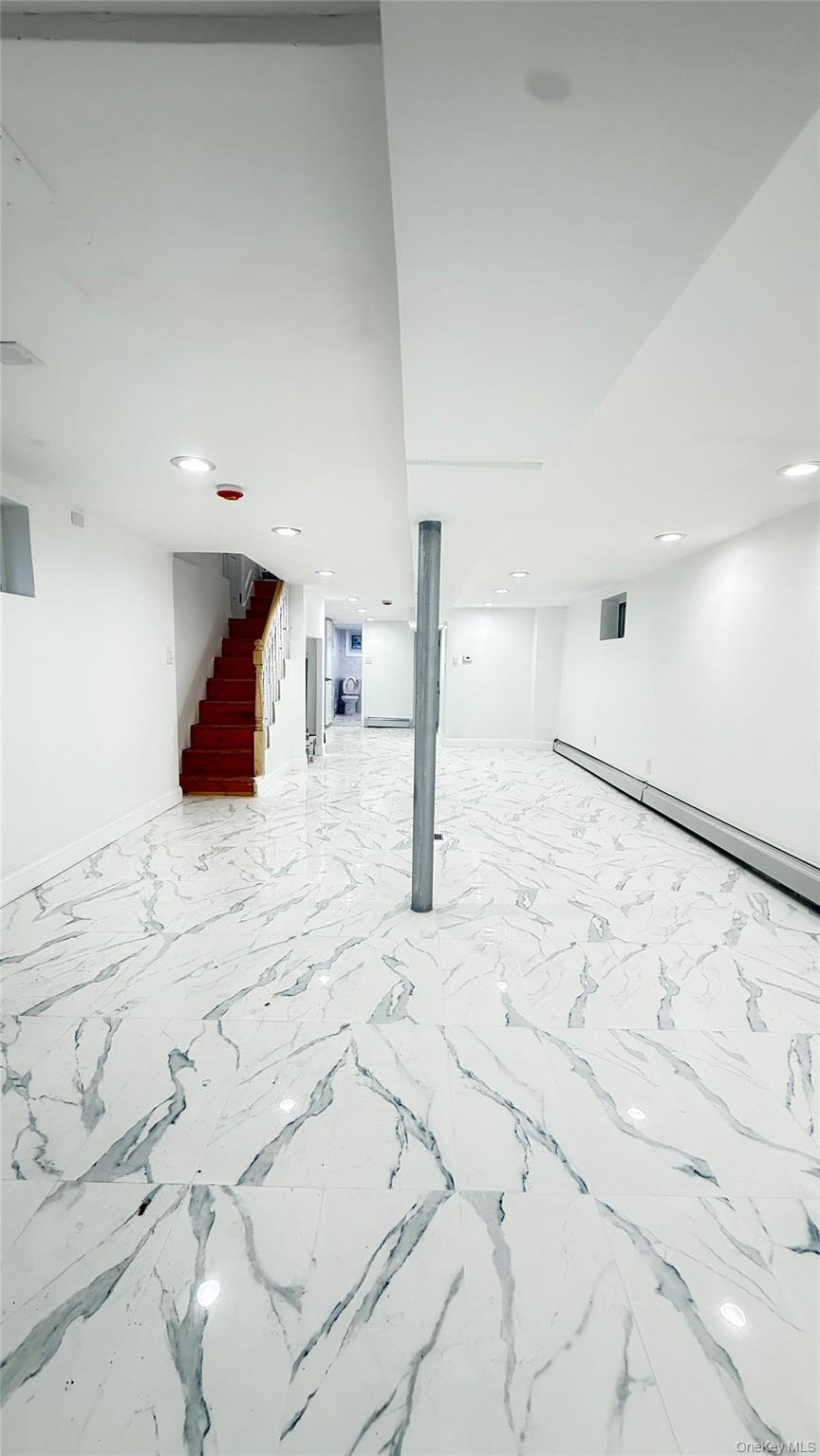 116-45 195th Street Queens, NY 11412 - Photo 19 of 21 a large white bed in a white room