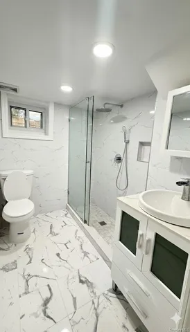 a bathroom with a sink toilet and shower
