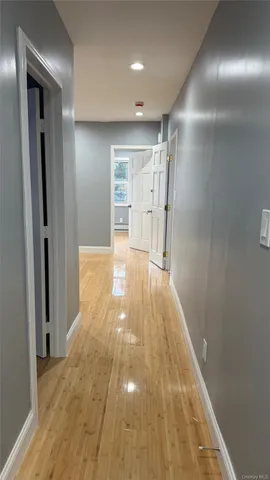 a view of hallway with wooden floor