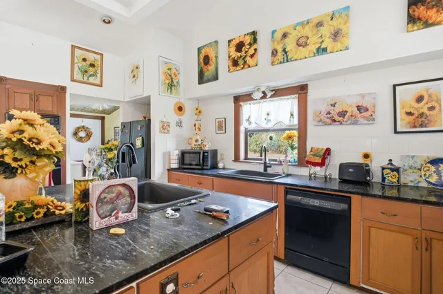 a kitchen with stainless steel appliances granite countertop a sink dishwasher stove and cabinets