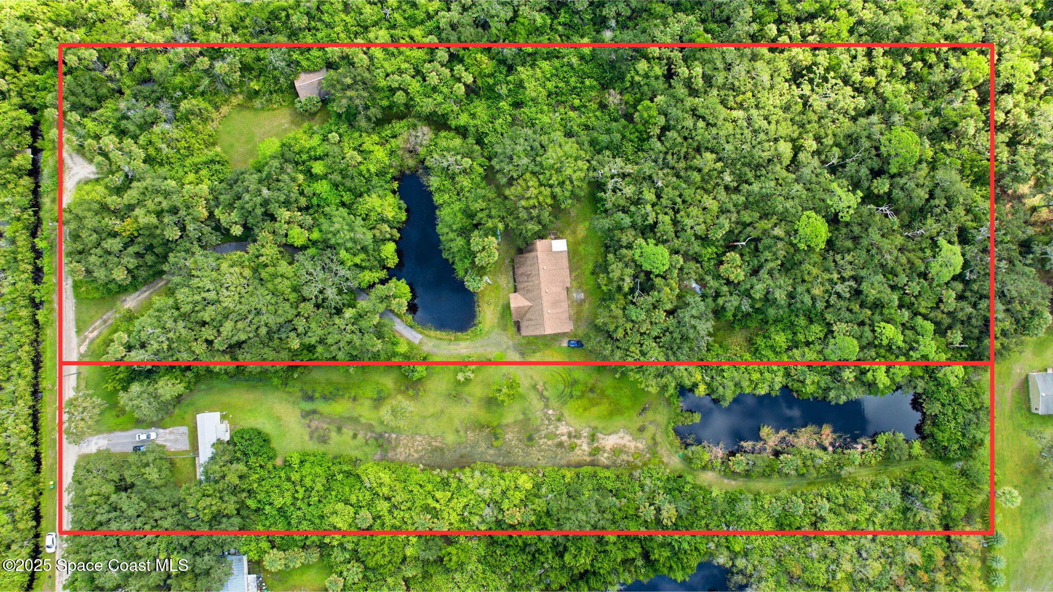 2821-2825 Lionel Road Mims, FL 32754 - Photo 2 of 42 a view of a garden with a tree