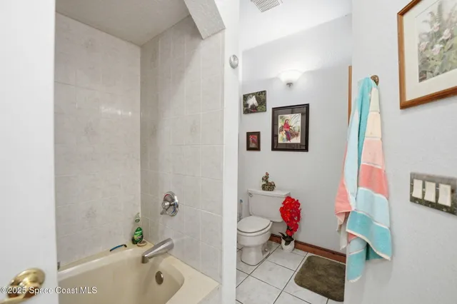 a bathroom with a bath tub a toilet and a shower curtain