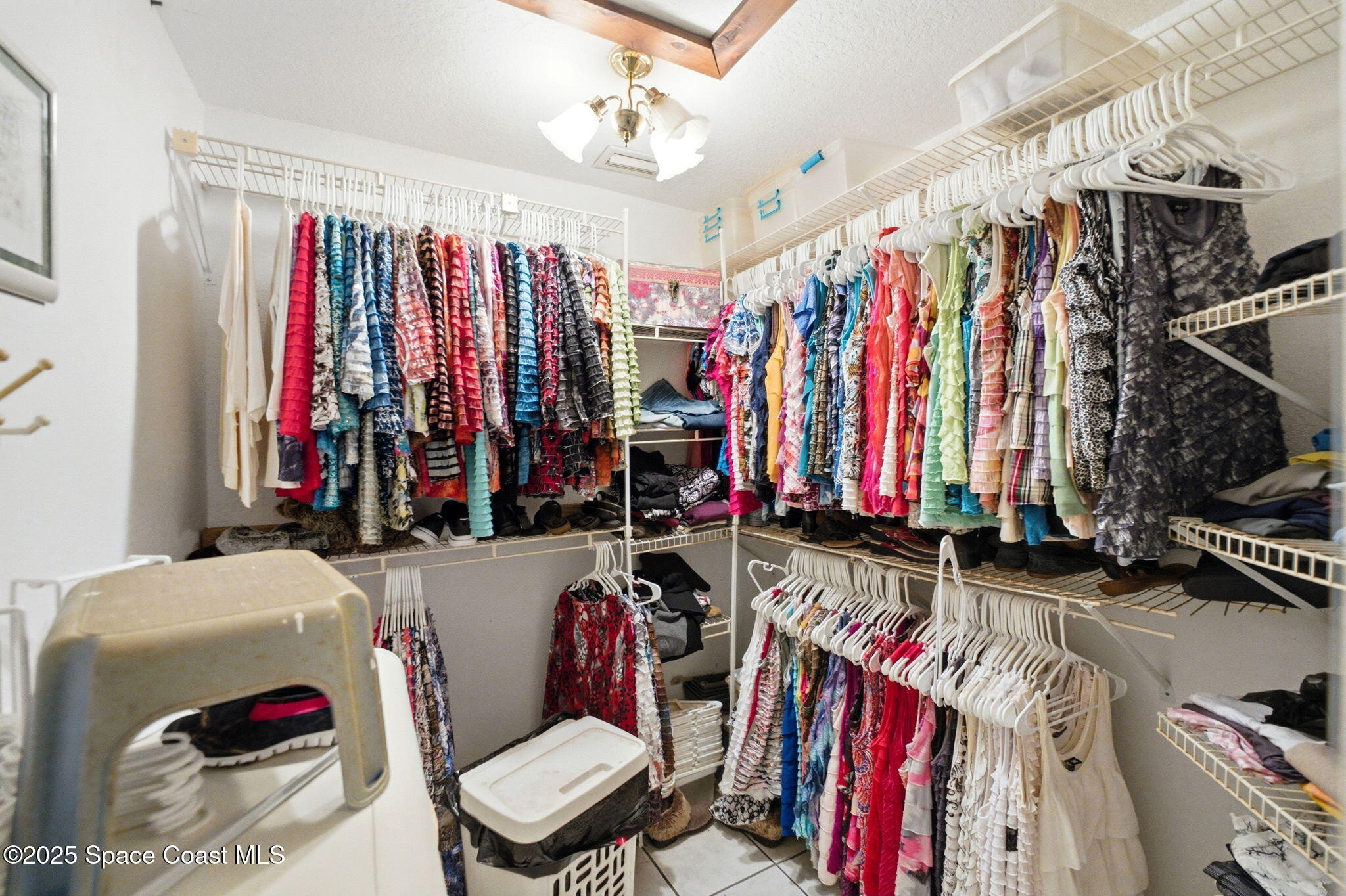 2821-2825 Lionel Road Mims, FL 32754 - Photo 22 of 42 a view of walk in closet with clothes