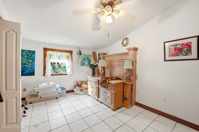 a living room with furniture a flat screen tv and a window