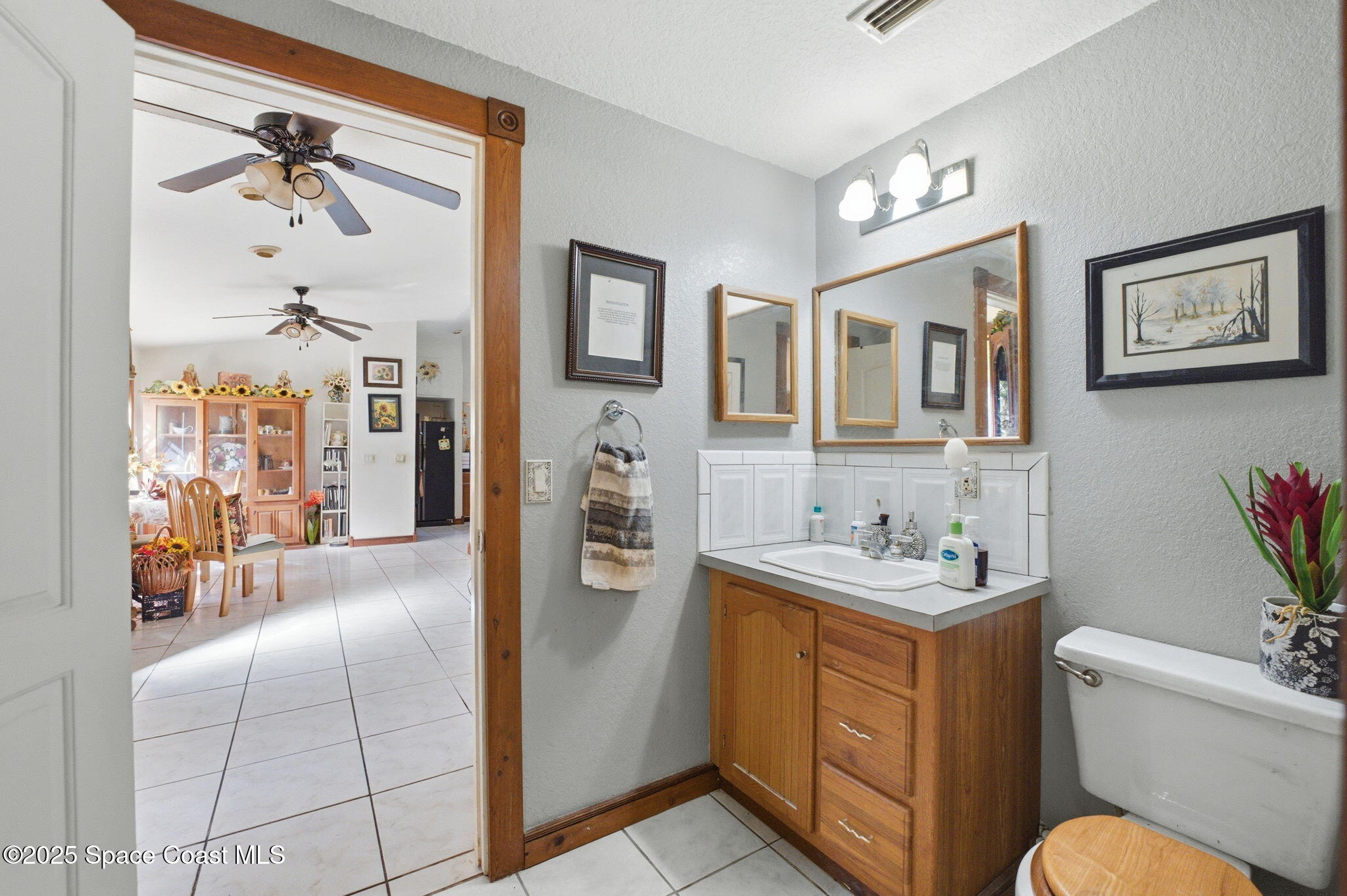 2821-2825 Lionel Road Mims, FL 32754 - Photo 26 of 42 a bathroom with a toilet sink and mirror