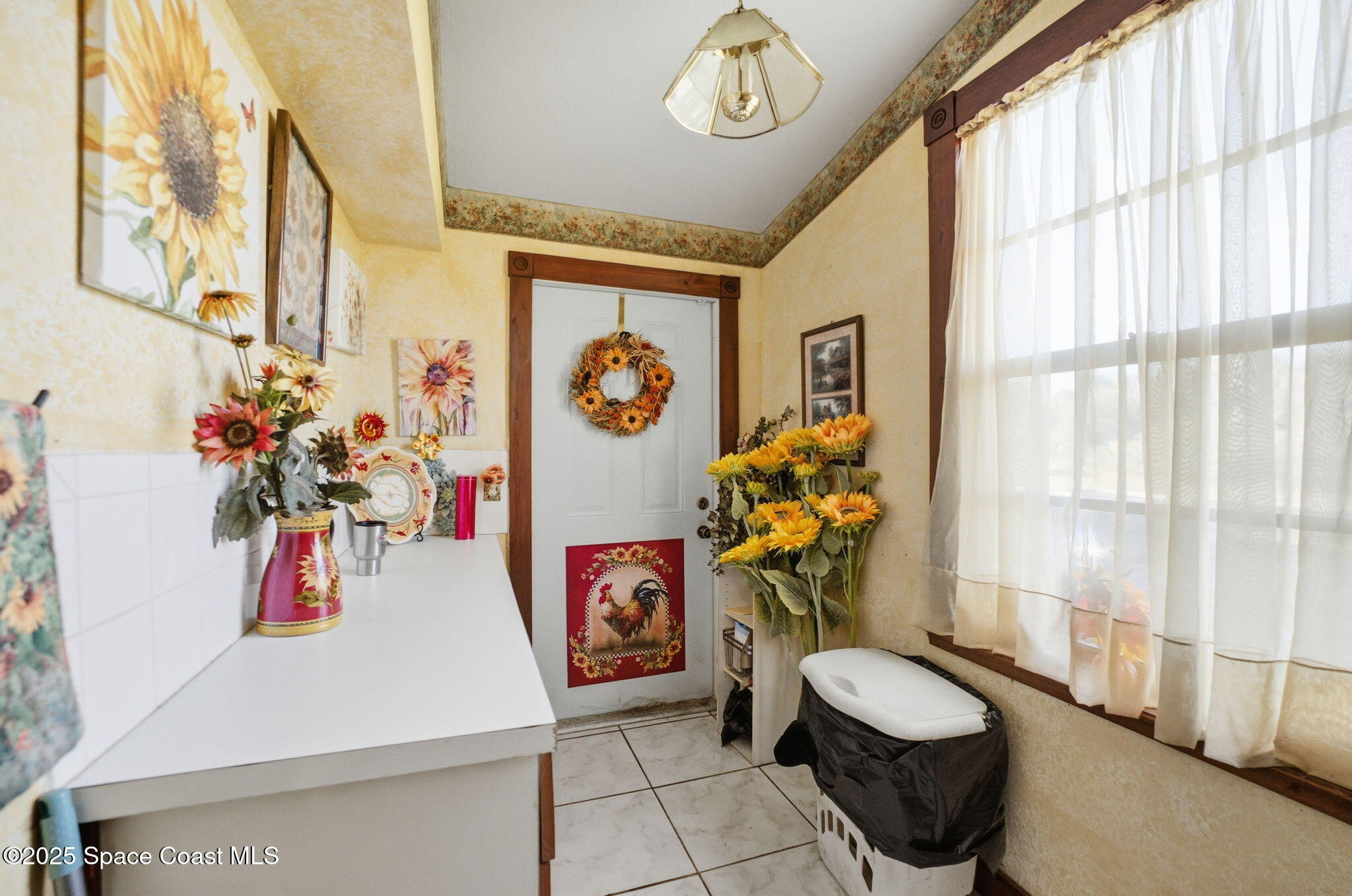 2821-2825 Lionel Road Mims, FL 32754 - Photo 29 of 42 a very nice looking room with a large window and a chandelier