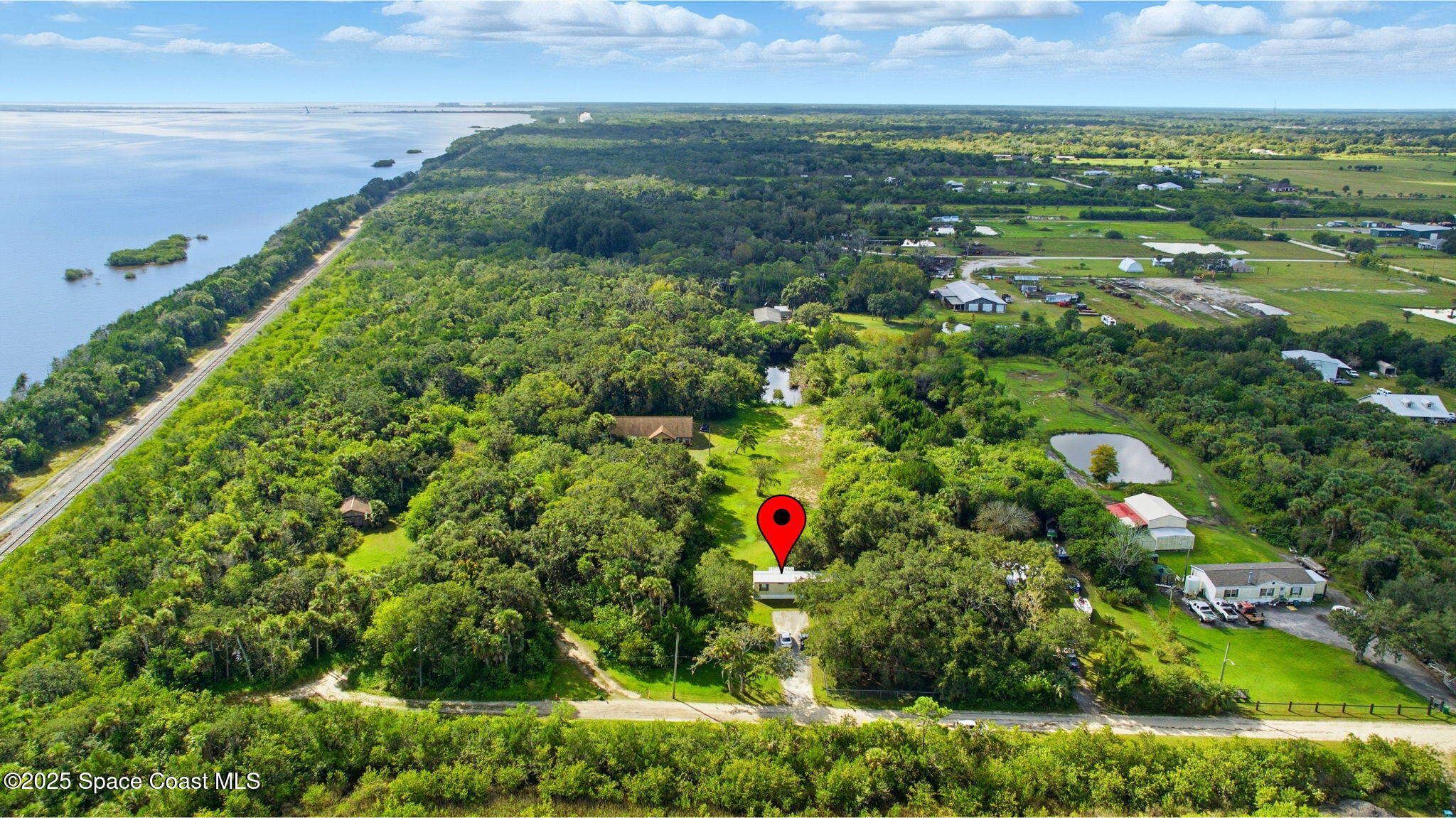 2821-2825 Lionel Road Mims, FL 32754 - Photo 40 of 42 a view of a garden with a lake