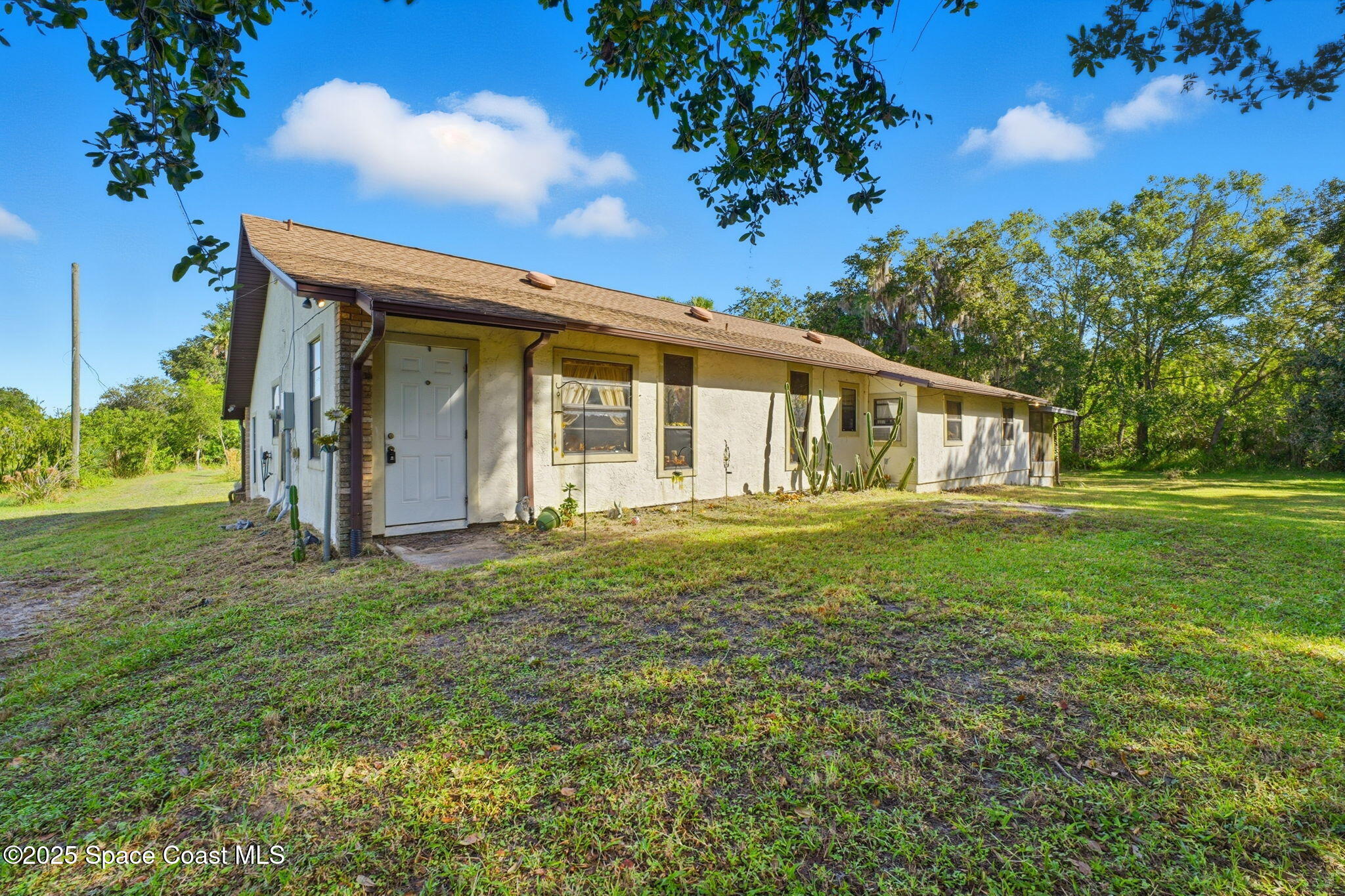2821-2825 Lionel Road Mims, FL 32754 - Photo 4 of 42 a view of a house with a backyard