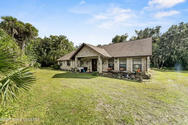 a front view of a house with swimming pool and porch with furniture