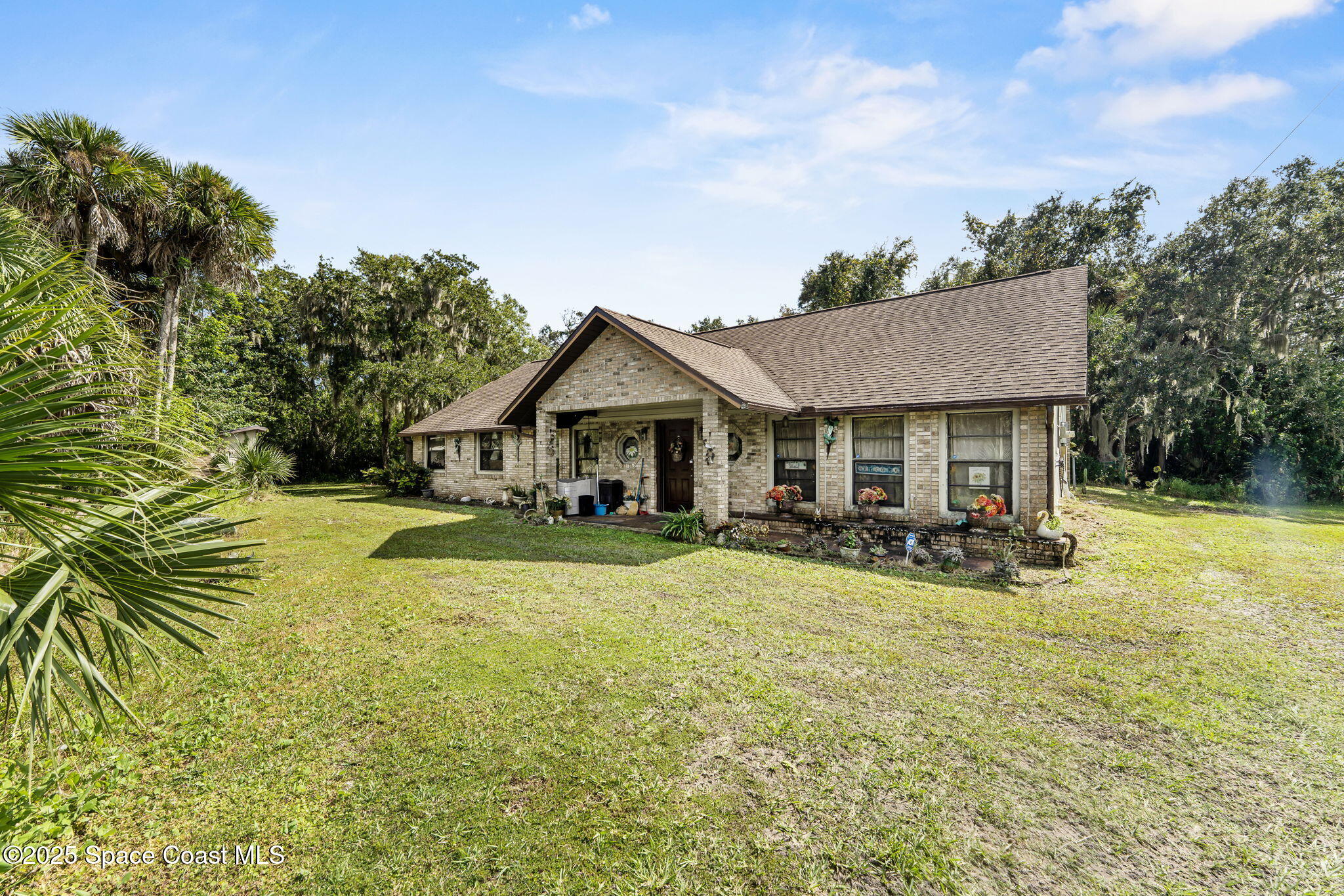 2821-2825 Lionel Road Mims, FL 32754 - Photo 7 of 42 a front view of a house with swimming pool and porch with furniture