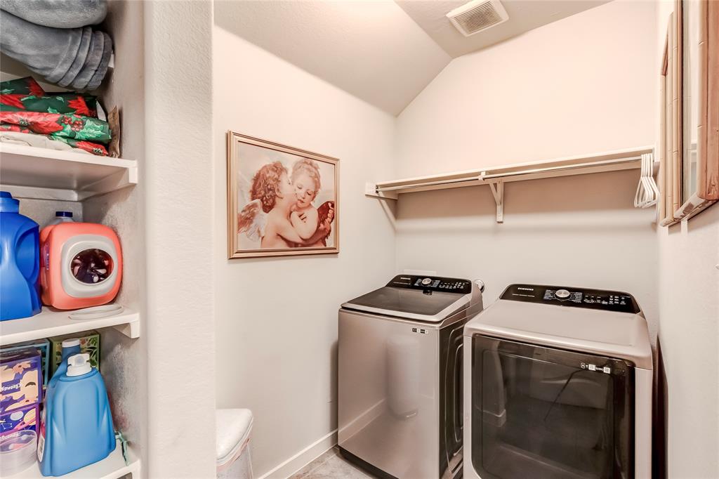 231 Windswept Way Kyle, TX 78640 - Photo 23 of 33 Laundry area featuring independent washer and dryer, storage and vaulted ceiling