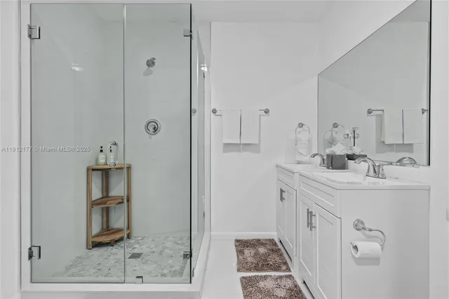 a bathroom with double vanity sink and a mirror