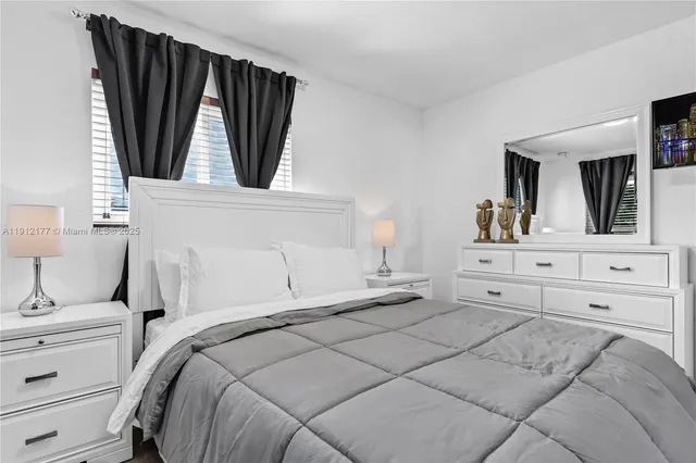 a bedroom with a bed and a mirror