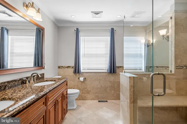 a bathroom with a sink a toilet and a shower