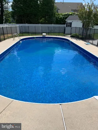 a view of swimming pool with a chair and couch