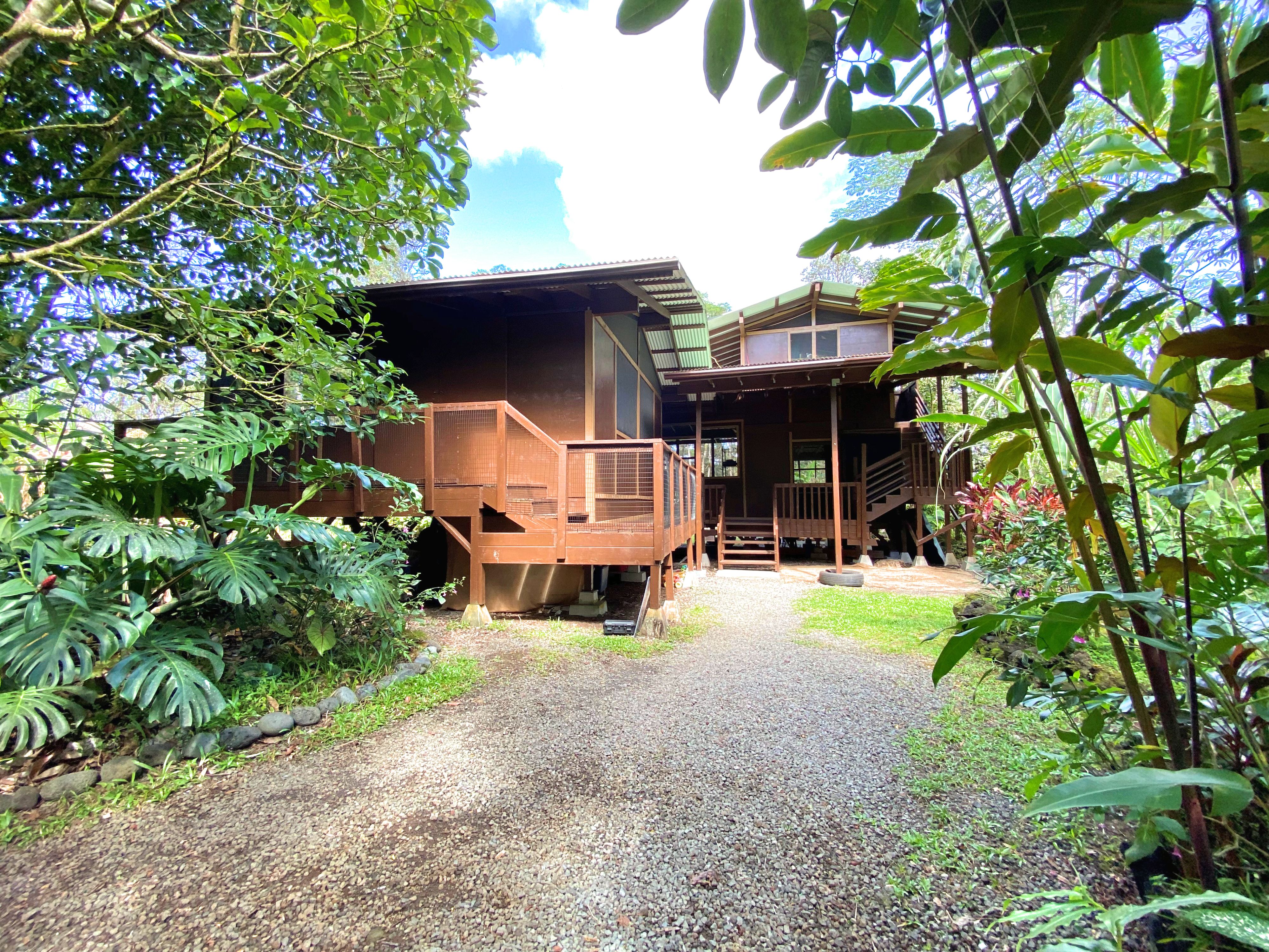 a view of a house with pool and sitting area