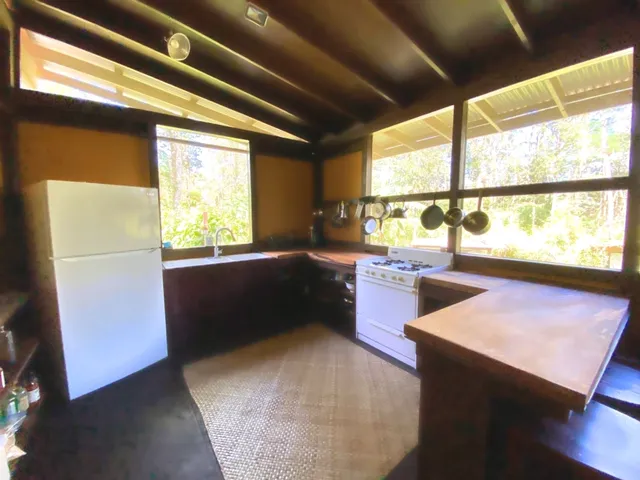 a kitchen with a large window in it and kitchen