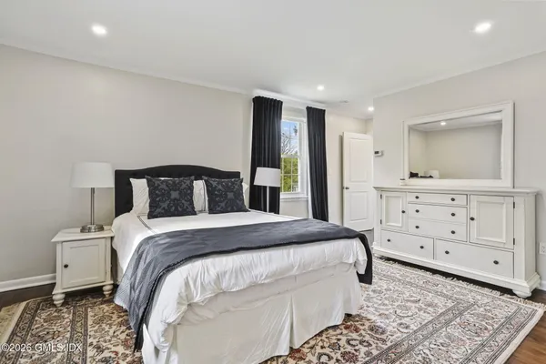 a bedroom with a bed and a dresser