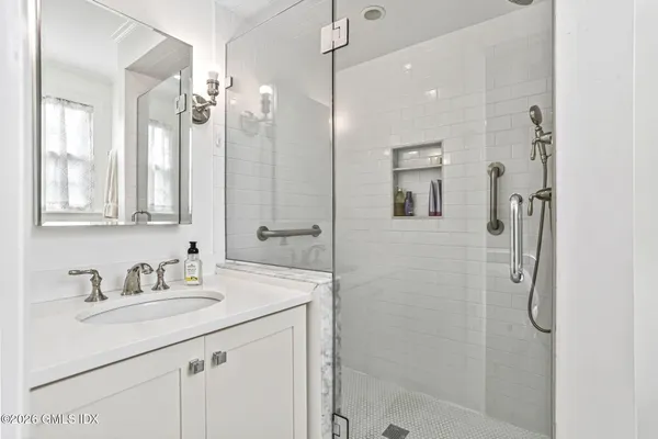 a bathroom with a sink double vanity and shower