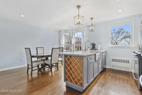 a view of a dining room with furniture wooden floor and chandelier